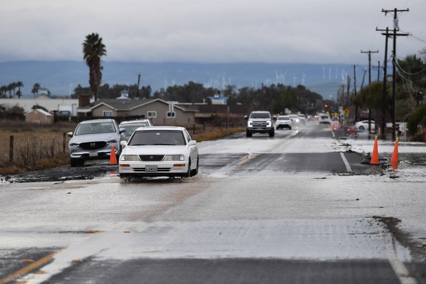 Vehicles travel slowly on a flooded Bixler Road in Brentwood, Calif., on Monday, January 16, 2023. (Jose Carlos Fajardo/Bay Area News Group)